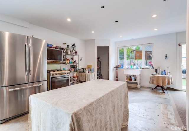 kitchen with recessed lighting, gas range, and freestanding refrigerator