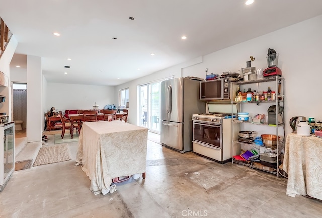 kitchen featuring recessed lighting, stainless steel appliances, and concrete floors