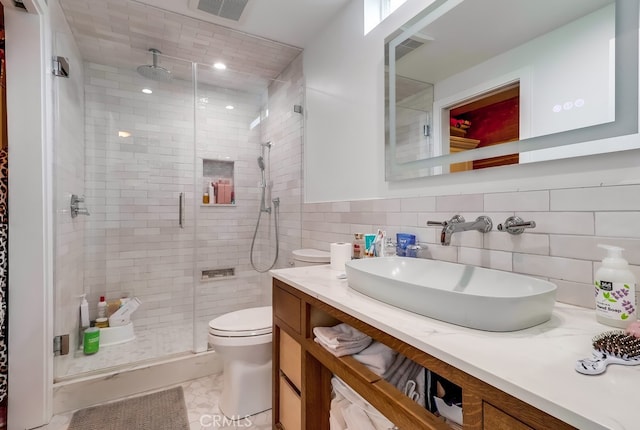 full bathroom featuring visible vents, a stall shower, toilet, and vanity