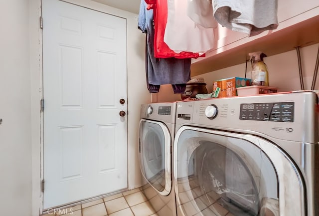 laundry area with tile patterned flooring, laundry area, and washing machine and clothes dryer