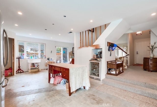 kitchen with recessed lighting, wine cooler, concrete flooring, and freestanding refrigerator