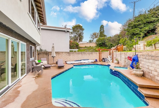 view of swimming pool featuring a patio, a fenced backyard, and a fenced in pool