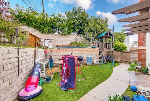 view of jungle gym with a patio, a fenced backyard, and a lawn