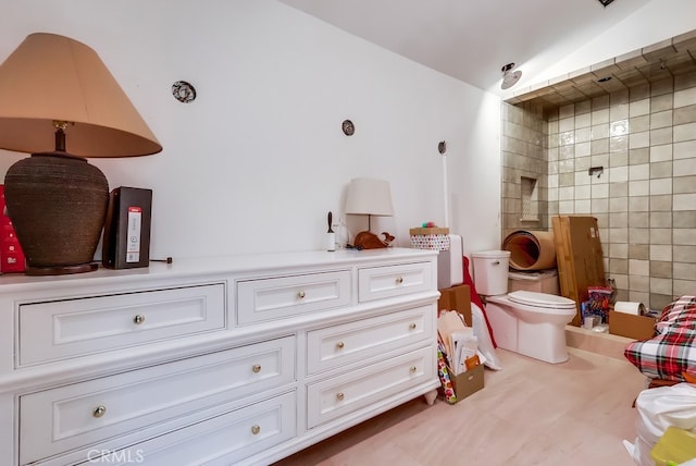 full bath with tile walls, toilet, and a tile shower