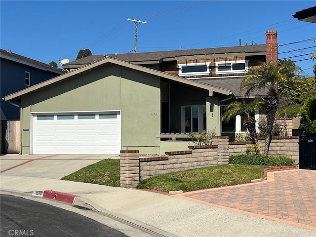 view of front facade with stucco siding, concrete driveway, and a garage