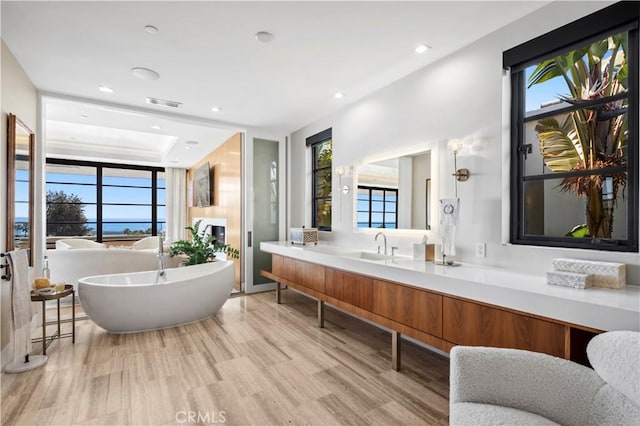 2914 Ocean Blvd, Corona Del Mar, CA 92625 - bathroom with visible vents, wood finished floors, recessed lighting, a freestanding bath, and vanity