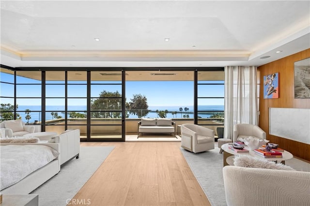 2914 Ocean Blvd, Corona Del Mar, CA 92625 - bedroom featuring wooden walls, a water view, a tray ceiling, wood finished floors, and access to outside