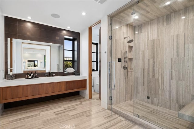 2914 Ocean Blvd, Corona Del Mar, CA 92625 - full bathroom with vanity, wood finished floors, tiled shower, recessed lighting, and toilet