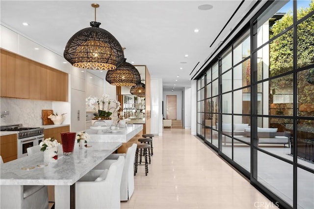2914 Ocean Blvd, Corona Del Mar, CA 92625 - kitchen with tasteful backsplash, double oven range, an inviting chandelier, a large island, and modern cabinets
