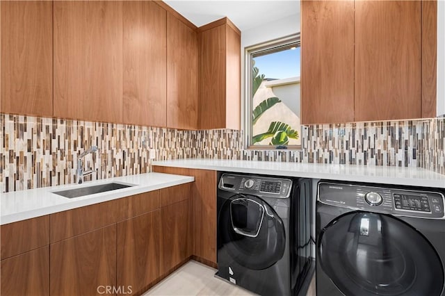 2914 Ocean Blvd, Corona Del Mar, CA 92625 - laundry room featuring a sink, cabinet space, and separate washer and dryer