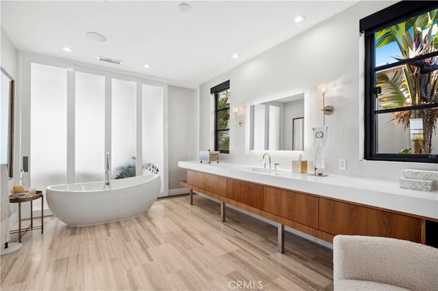 2914 Ocean Blvd, Corona Del Mar, CA 92625 - full bath featuring vanity, wood finished floors, visible vents, recessed lighting, and a freestanding bath