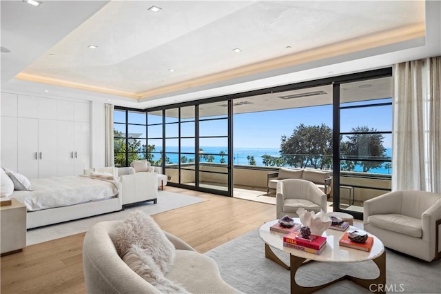 2914 Ocean Blvd, Corona Del Mar, CA 92625 - bedroom featuring access to exterior, a raised ceiling, wood finished floors, and a water view