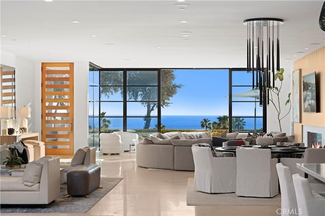 2914 Ocean Blvd, Corona Del Mar, CA 92625 - living area with recessed lighting, expansive windows, a water view, and a warm lit fireplace