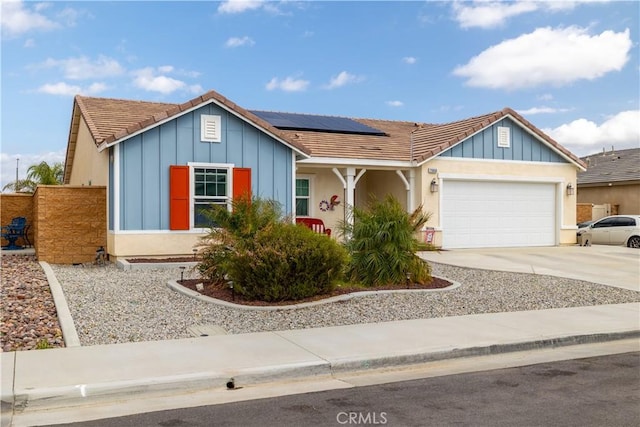 29068 Aubrey Cir, Winchester, CA 92596 - ranch-style house with roof mounted solar panels, driveway, a garage, and board and batten siding