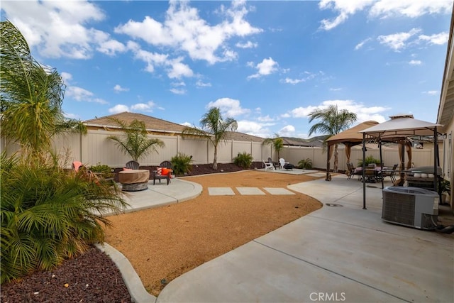 29068 Aubrey Cir, Winchester, CA 92596 - view of patio featuring a fenced backyard, a fire pit, a gazebo, and central AC