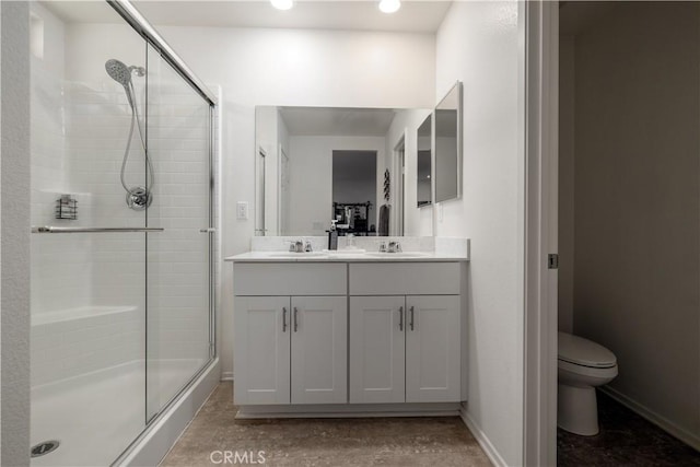 29068 Aubrey Cir, Winchester, CA 92596 - bathroom with toilet, baseboards, a sink, a stall shower, and double vanity