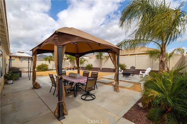 29068 Aubrey Cir, Winchester, CA 92596 - view of patio / terrace featuring outdoor dining area, a fenced backyard, a fire pit, and a gazebo