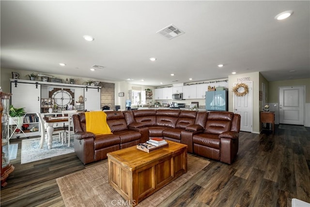 29068 Aubrey Cir, Winchester, CA 92596 - living room featuring dark wood finished floors, visible vents, a barn door, and recessed lighting