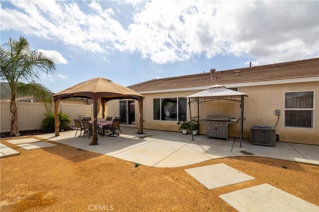 29068 Aubrey Cir, Winchester, CA 92596 - back of property featuring cooling unit, stucco siding, fence, a gazebo, and a patio area
