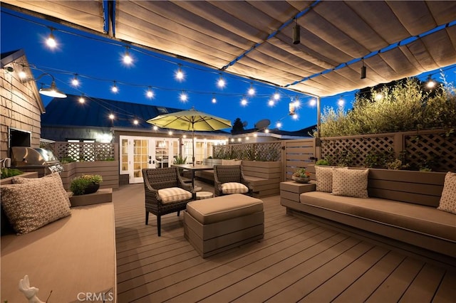 604 Begonia Ave, Corona Del Mar, CA 92625 - deck at night with french doors and an outdoor hangout area