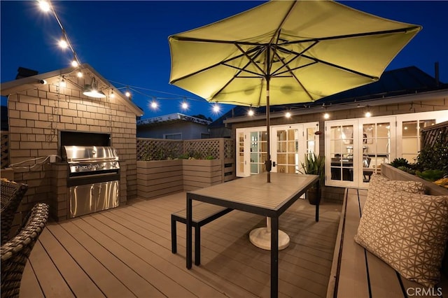 604 Begonia Ave, Corona Del Mar, CA 92625 - deck at twilight featuring outdoor dining space, grilling area, french doors, and an outdoor kitchen