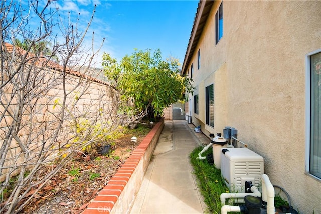 view of side of home featuring stucco siding and a fenced backyard