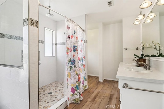 1202 W Lancaster Blvd, Lancaster, CA 93534 - bathroom with a shower stall, double vanity, and wood finished floors