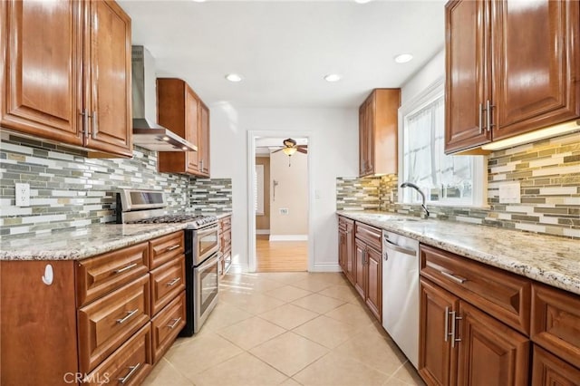 1202 W Lancaster Blvd, Lancaster, CA 93534 - kitchen featuring wall chimney exhaust hood, appliances with stainless steel finishes, light stone counters, baseboards, and recessed lighting