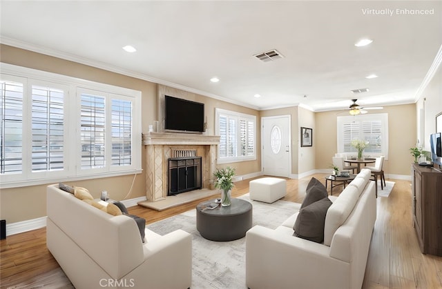 1202 W Lancaster Blvd, Lancaster, CA 93534 - living area with crown molding, baseboards, a ceiling fan, a premium fireplace, and light wood finished floors