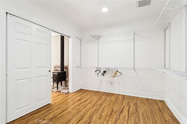 1202 W Lancaster Blvd, Lancaster, CA 93534 - walk in closet with wood finished floors and a wood stove