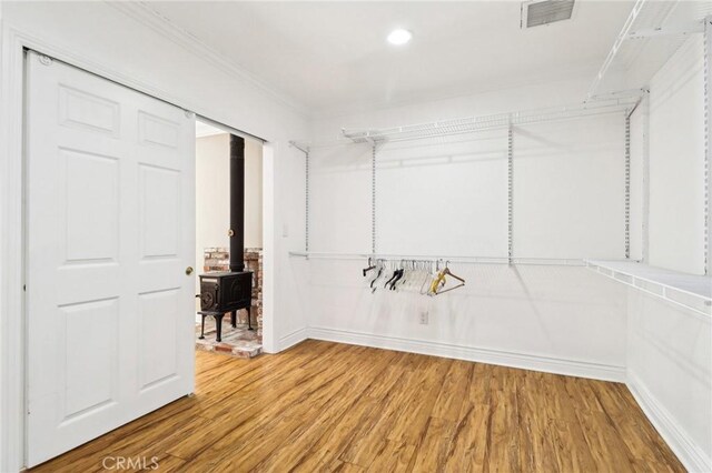 1202 W Lancaster Blvd, Lancaster, CA 93534 - walk in closet featuring wood finished floors and a wood stove