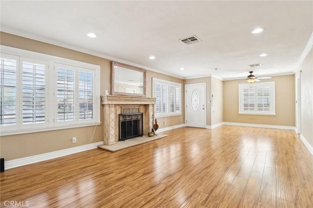 1202 W Lancaster Blvd, Lancaster, CA 93534 - unfurnished living room with crown molding, plenty of natural light, a ceiling fan, a fireplace, and baseboards