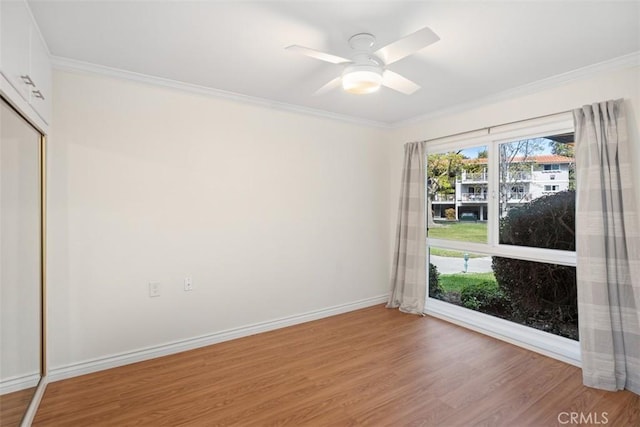 647 Avenida Sevilla Unit A, Laguna Woods, CA 92637 - spare room with crown molding, baseboards, light wood finished floors, and a ceiling fan