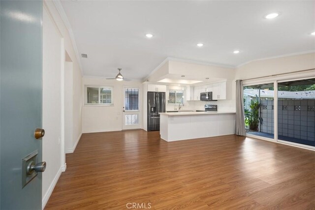 647 Avenida Sevilla Unit A, Laguna Woods, CA 92637 - kitchen with ornamental molding, open floor plan, a peninsula, and stainless steel appliances