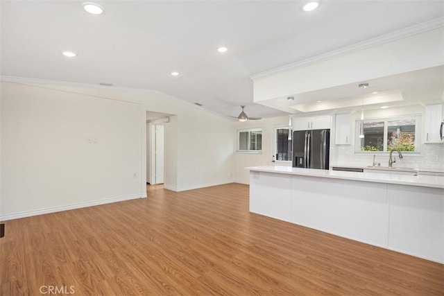 647 Avenida Sevilla Unit A, Laguna Woods, CA 92637 - unfurnished living room featuring recessed lighting, light wood-style flooring, a sink, and crown molding