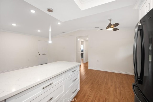 647 Avenida Sevilla Unit A, Laguna Woods, CA 92637 - kitchen featuring crown molding, freestanding refrigerator, light wood-style flooring, white cabinets, and decorative light fixtures