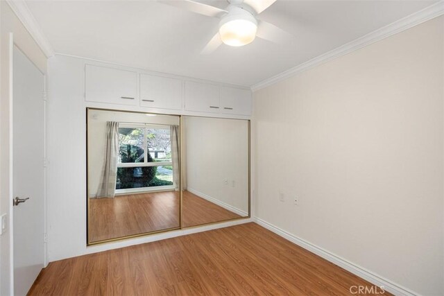 647 Avenida Sevilla Unit A, Laguna Woods, CA 92637 - unfurnished bedroom with baseboards, light wood-type flooring, a closet, crown molding, and a ceiling fan