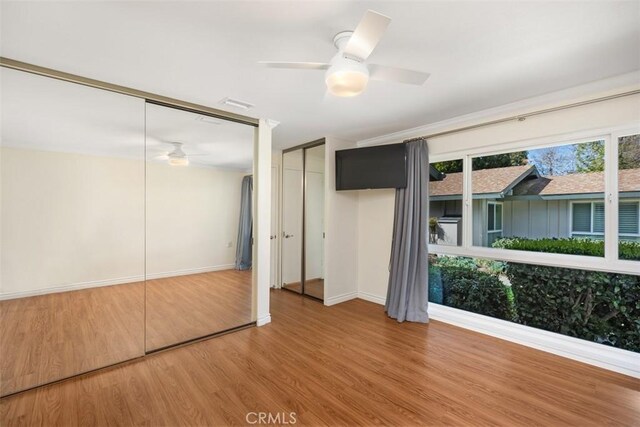 647 Avenida Sevilla Unit A, Laguna Woods, CA 92637 - unfurnished bedroom featuring wood finished floors, baseboards, and a ceiling fan