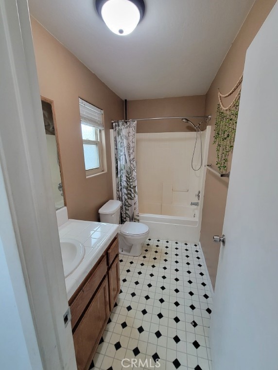 bathroom with vanity, toilet, and shower / bath combo with shower curtain