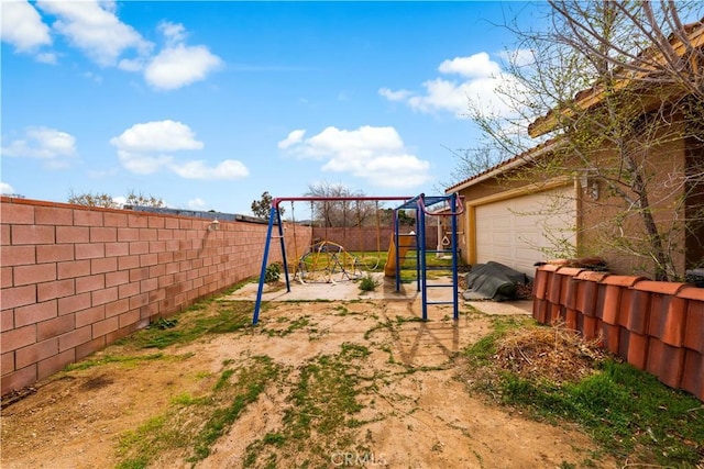 view of yard featuring a playground and a fenced backyard