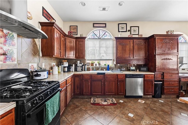 kitchen with black gas range, a sink, backsplash, extractor fan, and dishwasher