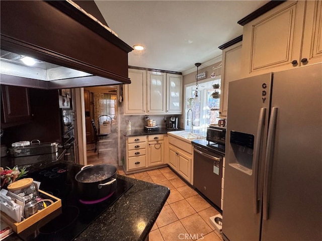 433 Oakmont Dr, Barstow, CA 92311 - kitchen featuring dark countertops, stainless steel fridge with ice dispenser, light tile patterned floors, dishwashing machine, and a sink