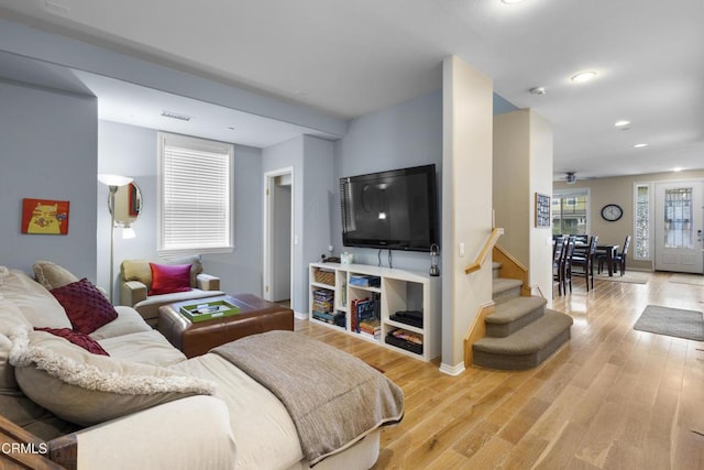 living area featuring visible vents, recessed lighting, stairway, and light wood-type flooring