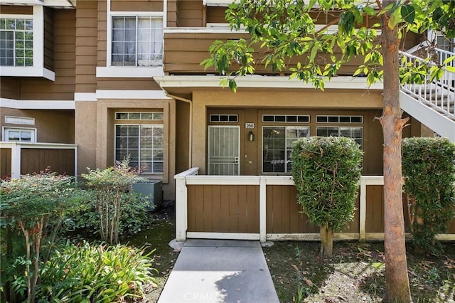 entrance to property featuring stucco siding