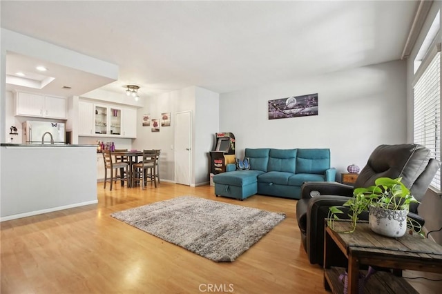 living area featuring light wood finished floors and recessed lighting