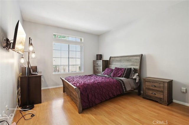 bedroom with baseboards and light wood-style flooring