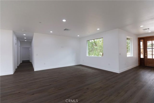 unfurnished living room featuring recessed lighting, baseboards, and dark wood-style flooring