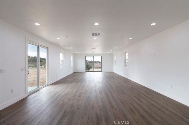 unfurnished living room with visible vents, recessed lighting, and wood finished floors
