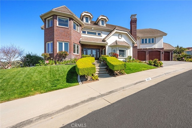 victorian home featuring a front yard, driveway, and a chimney