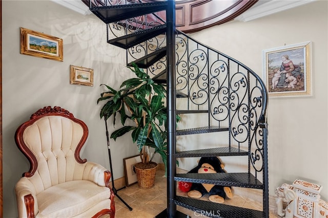 stairs with tile patterned flooring and crown molding